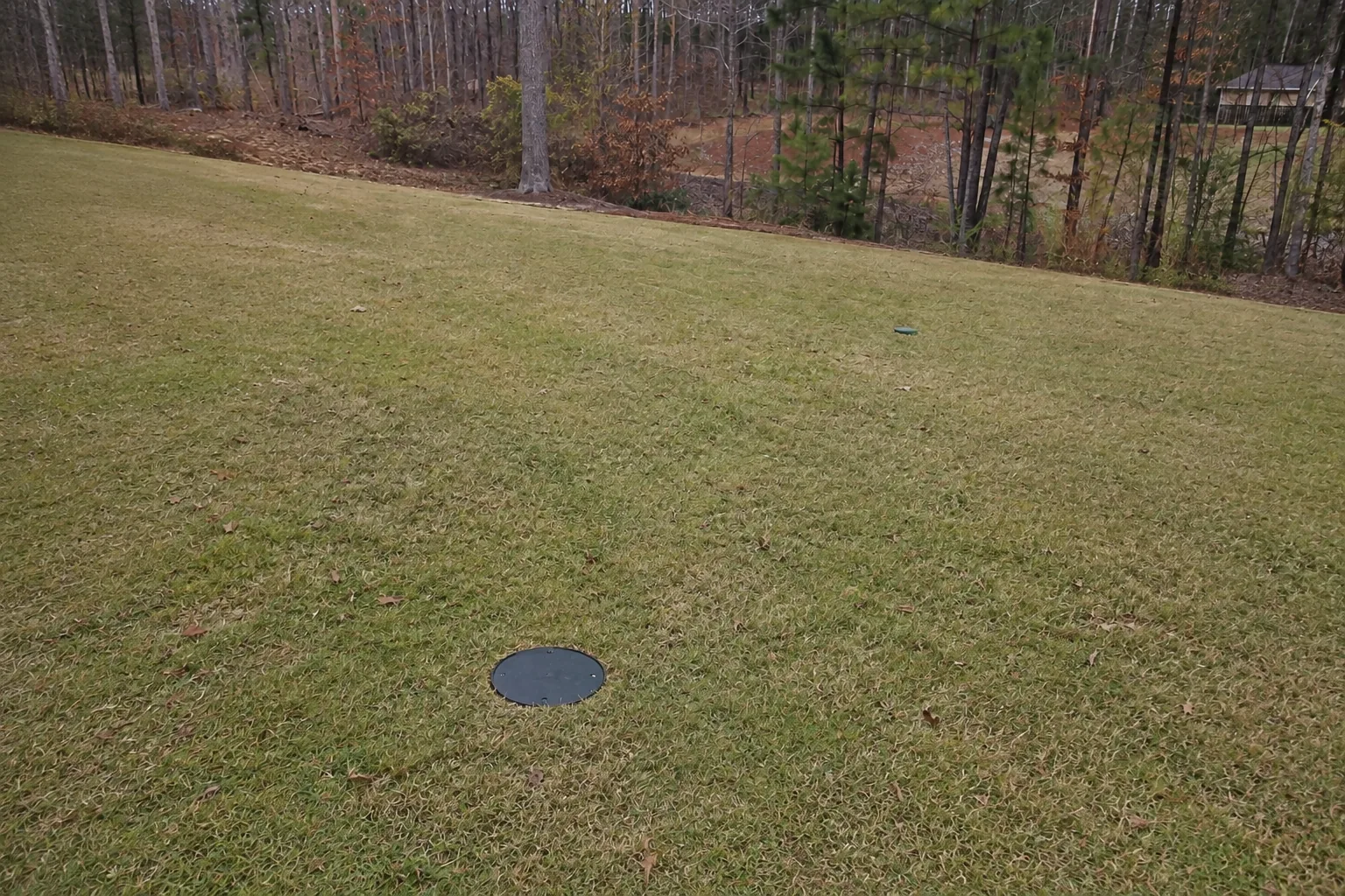 Flush exterior sump access and restored buried discharge route